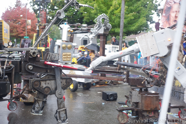 Motoman whacks the Running Machine with the baseball bat